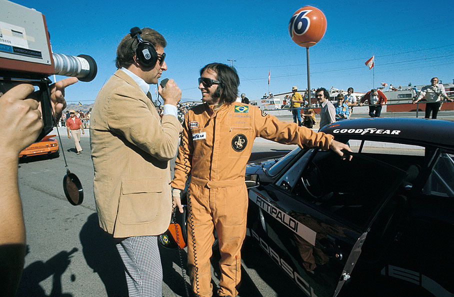 Emerson Fittipaldi is intervied besides a Porsche 911