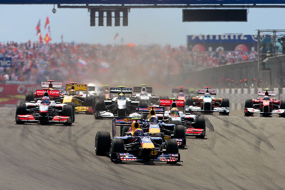 Both Red Bull cars take the lead into first corner, followed by the two McLarens
