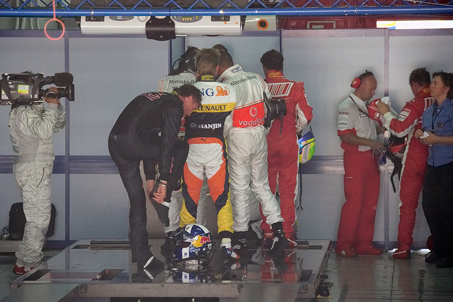 Drivers wait in line to be weighted on the FIA scales