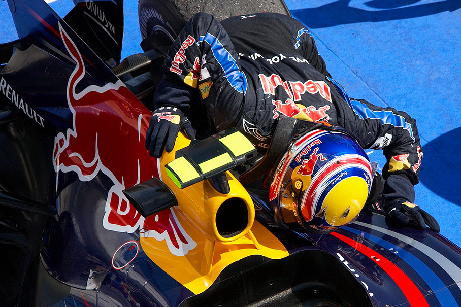 Race winner Mark Webber kisses his Red Bull-Renault car in parc ferme after bringing him to leadership