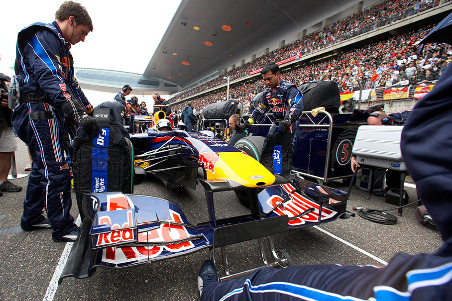 Sebastian Vettel's Red Bull Racing-Renault is being prepared on pole position