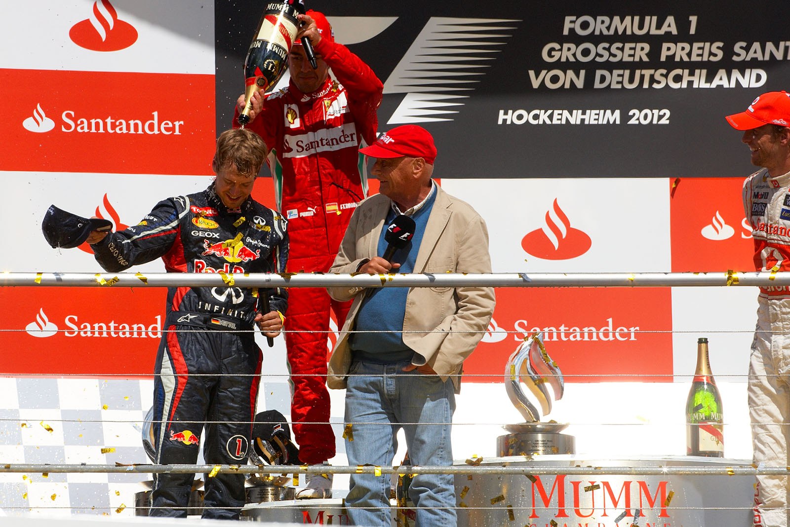 Race winner Fernando Alonso showers Sebastian Vettel with champagne on the podium after the German Grand Prix