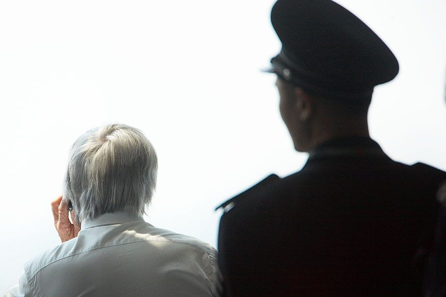 Bernie Ecclestone takes a phone call under surveillance