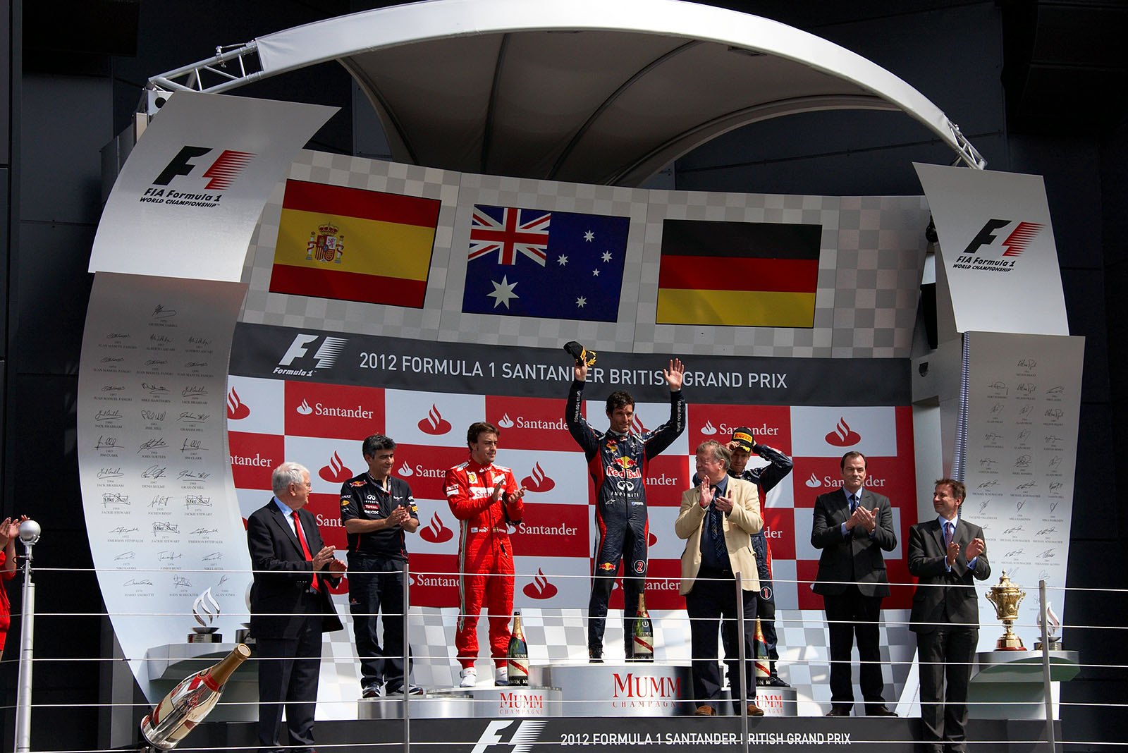 Race winner Mark Webber of Red Bull Racing celebrates on the podium