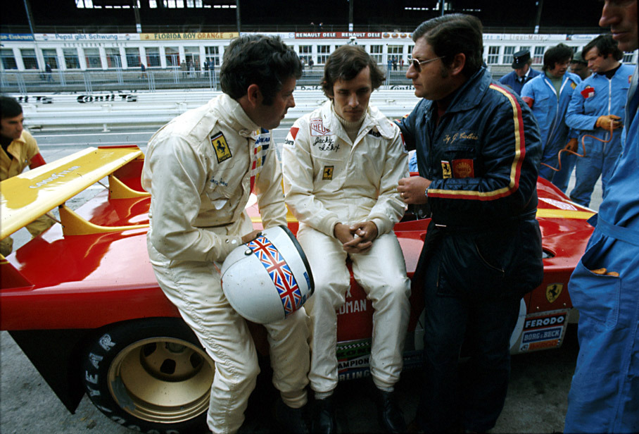 Jacky Ickx (B) and Brian Redman (GB) sit on their later winning Ferrari 312 PB #0888 	in pits, being caressed by chief designer Giacomo Caliri