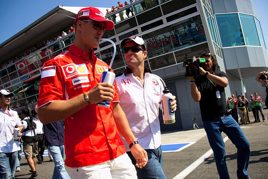 Ex-teammates Michael Schumacher and Rubens Barrichello strolling to drivers presentation