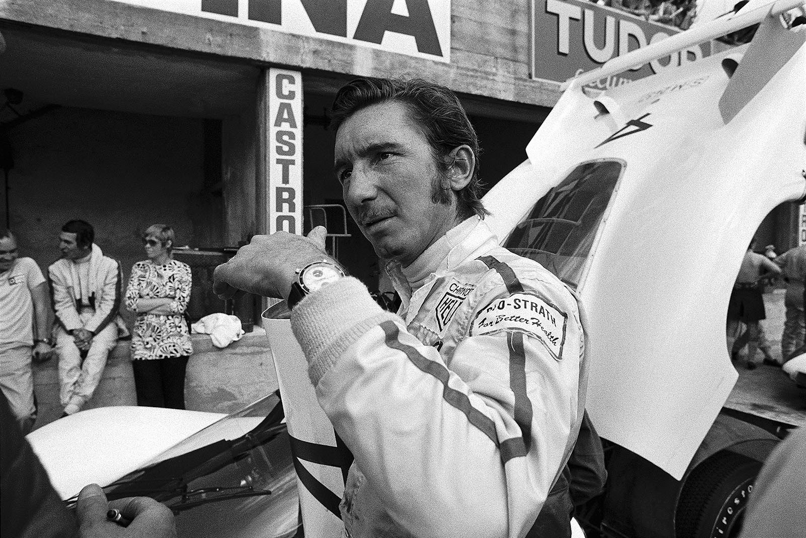 Jo Siffert in front of the Porsche 908 LH 026 in pits