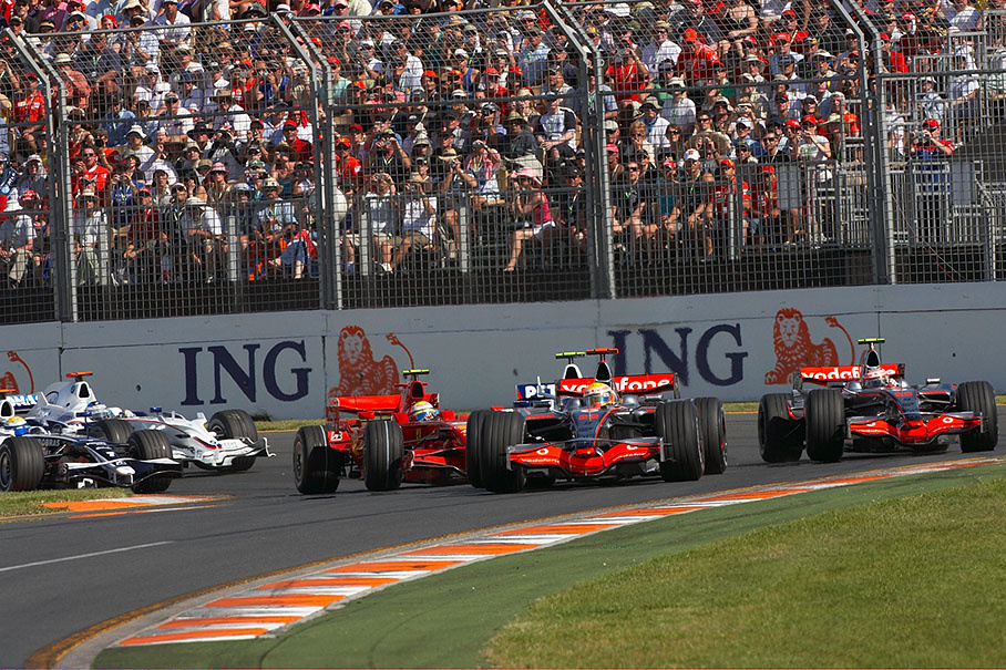The two McLarens turn around first corner, Massa squeezes behind