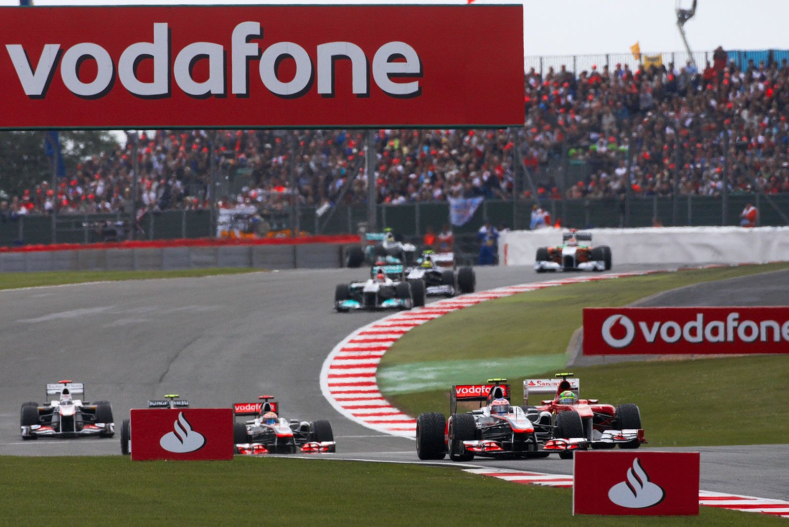 Jenson Button of McLaren in front of Ferrari's Massa and team mate Hamilton