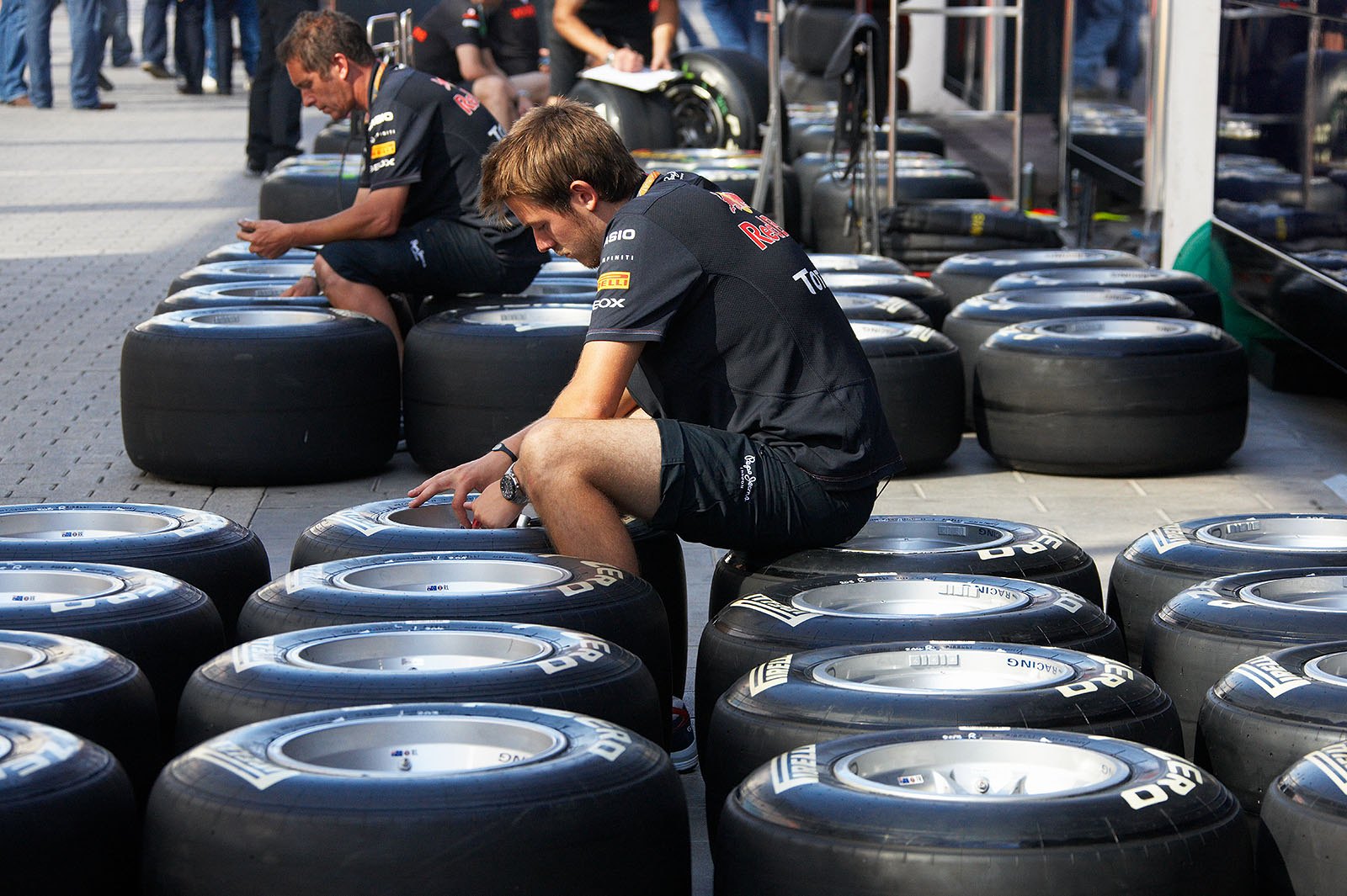 Red Bull mechanics prepare the tyres