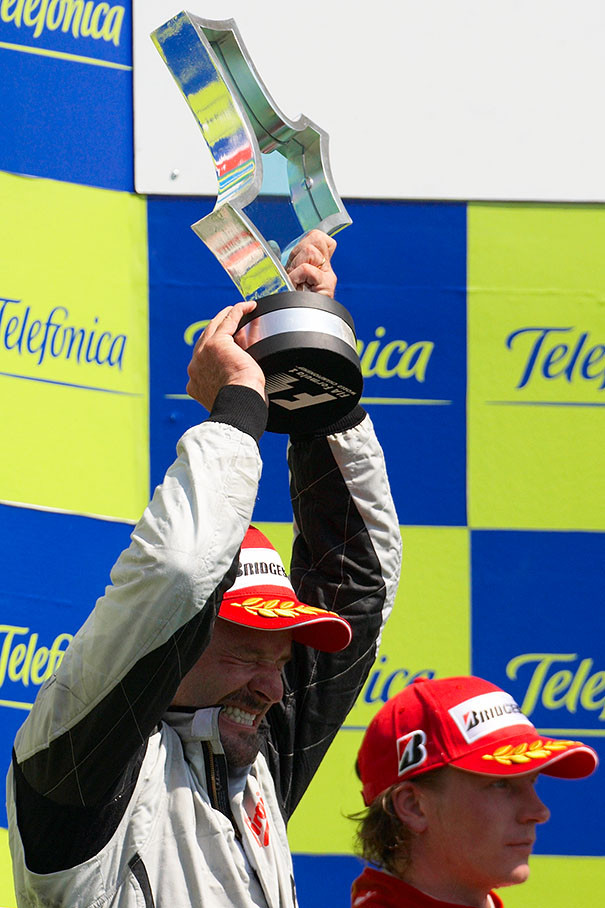 Race winner Rubens Barrichello shakes his tropy on podium