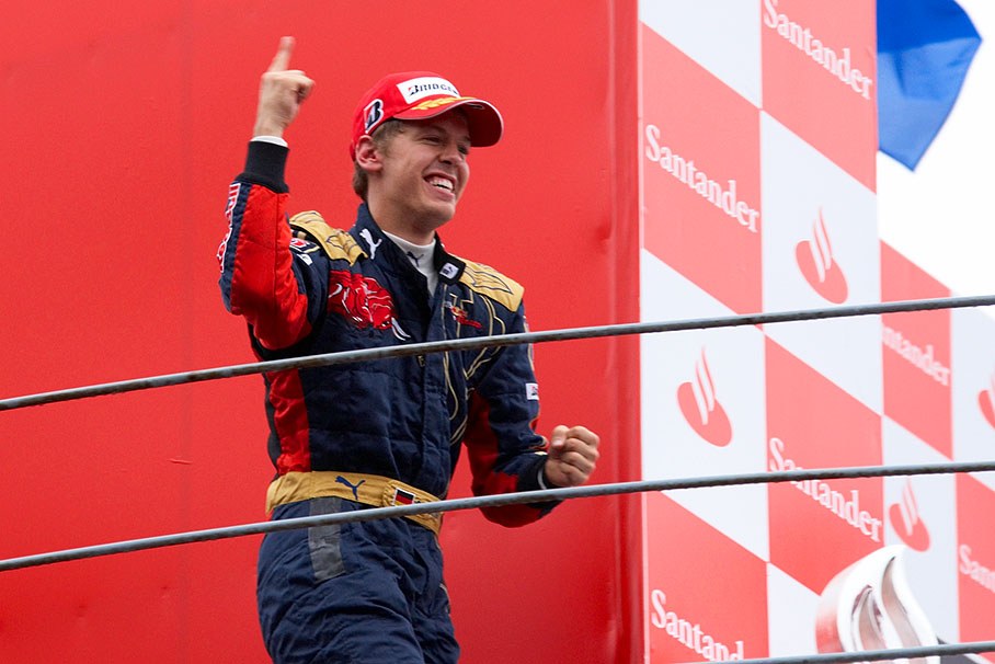 Happy race winner Sebastian Vettel runs on to podium