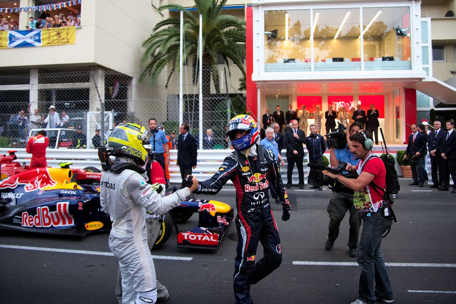 Race winner Mark Webber of Red Bull Racing receives congratulations from second placed Rosberg in parc ferme after the race