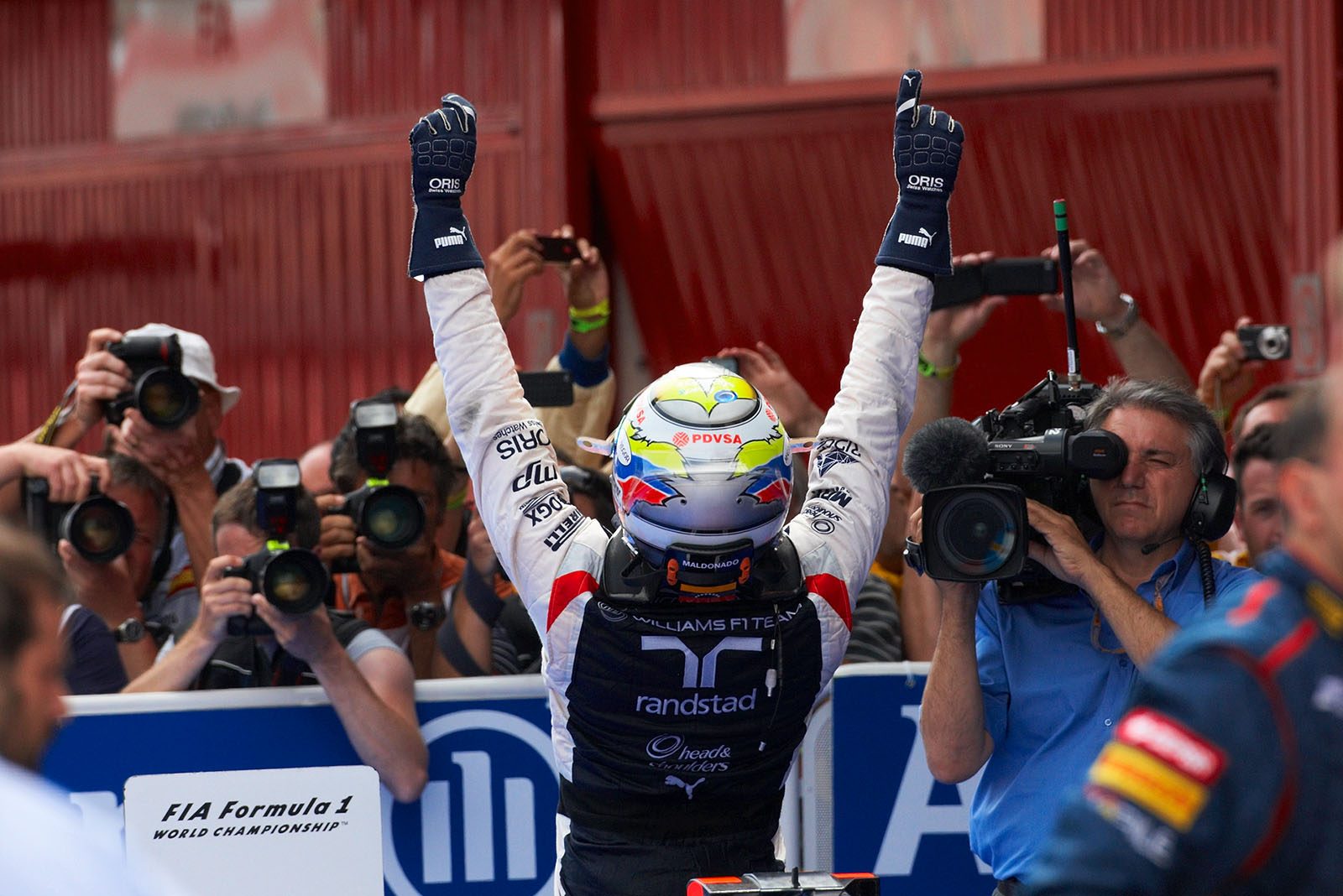 A victorious Pastor Maldonado of Williams cheers in parc ferme after winning the Spanish Grand Prix 2012