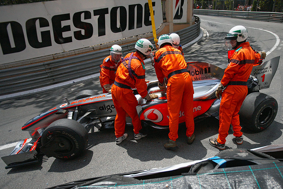 Lewis Hamilton's McLaren Mercedes is being towed away from track during Q1