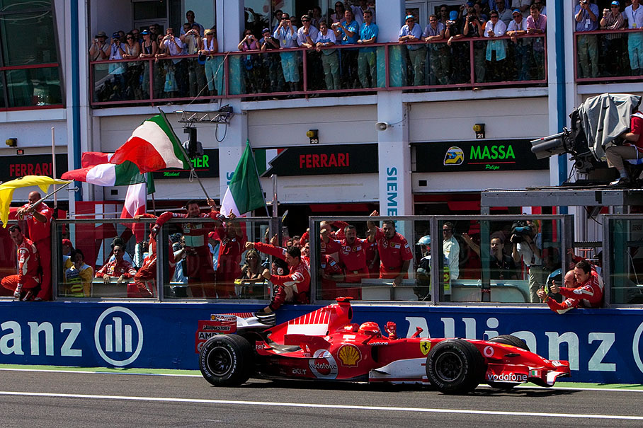 Michael Schumacher passing his cheering team