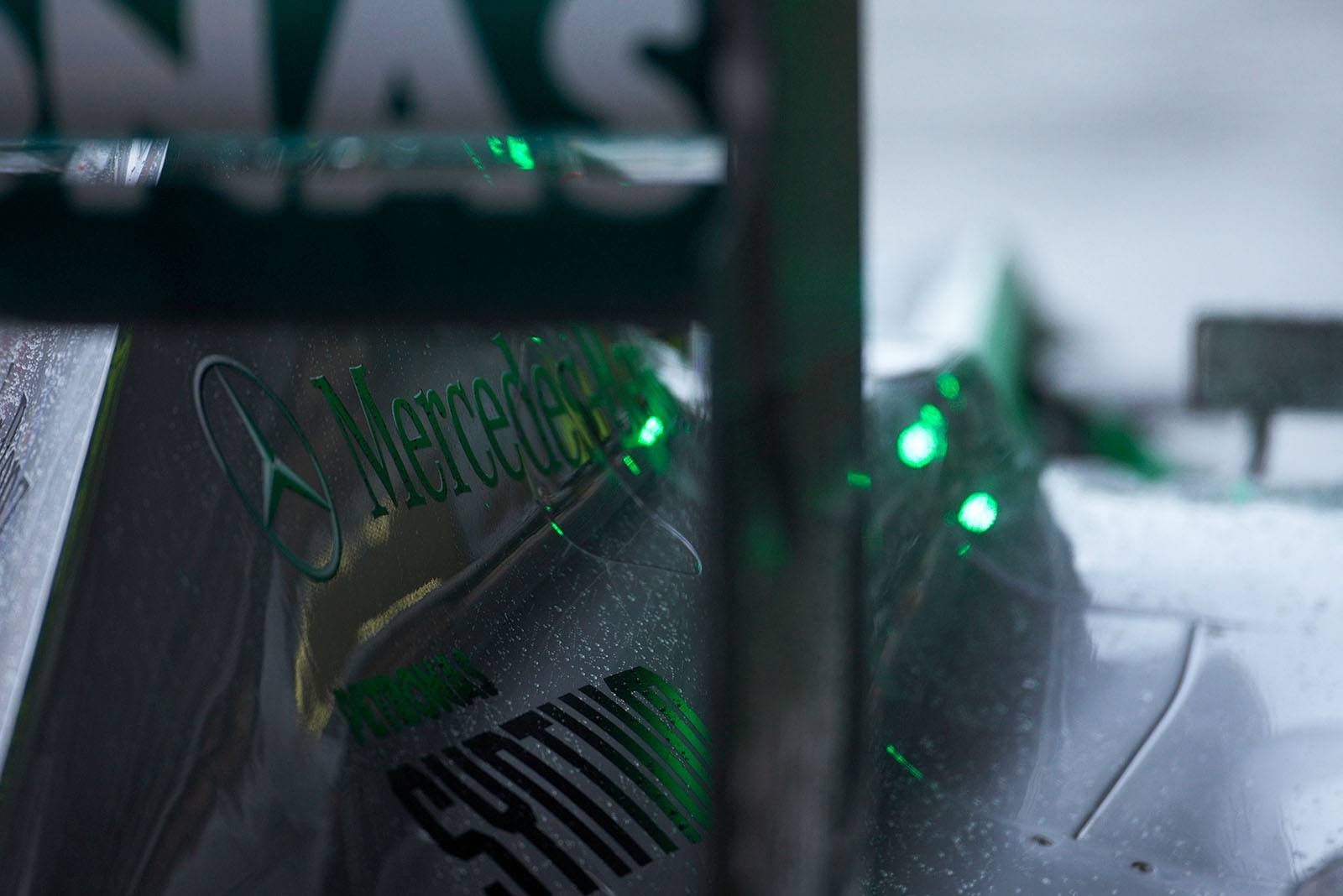 A reflection of the green pit signal on the outgoing Mercedes race car