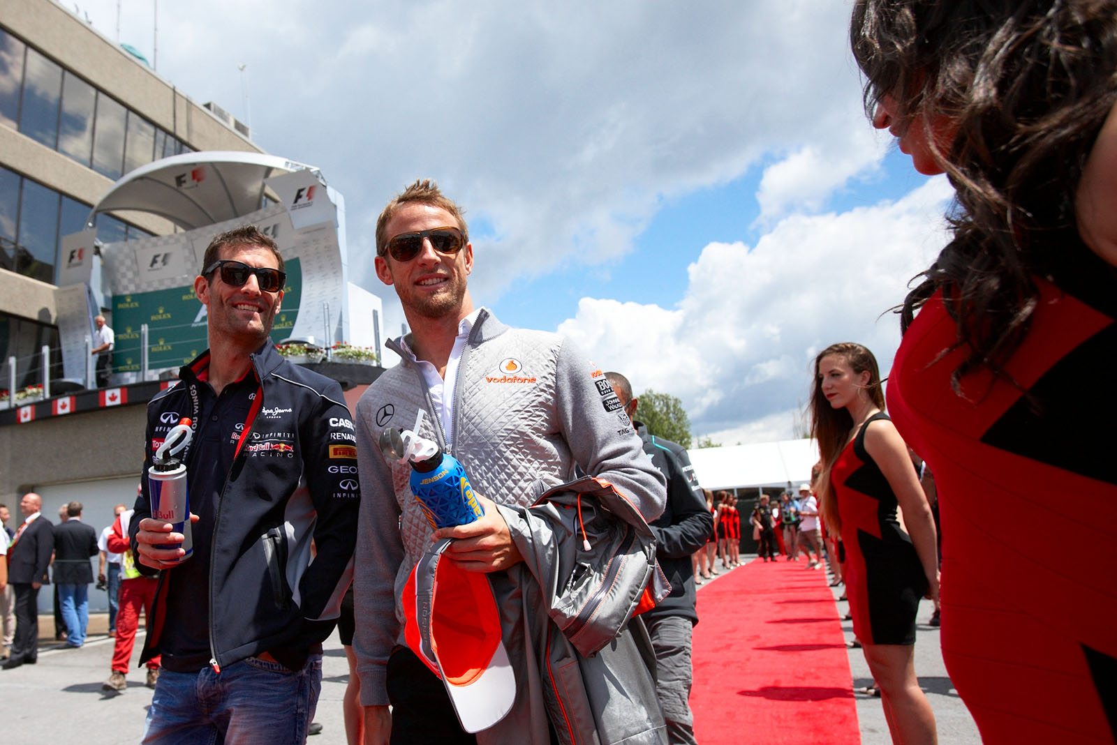 Jenson Button of McLaren strolls with RBRs Mark Webber