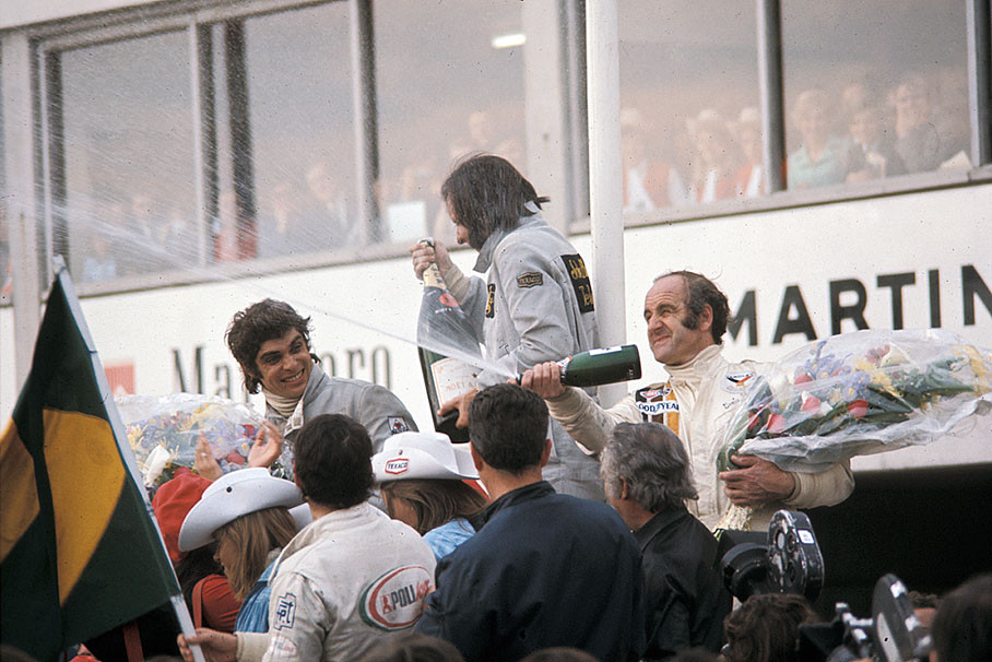 Race winner Emerson Fittipaldi celebrates on podium after the Belgian GP Nivelles-Baulers 1972 besides second placed Francois Cevert and third positioned Denny Hulme