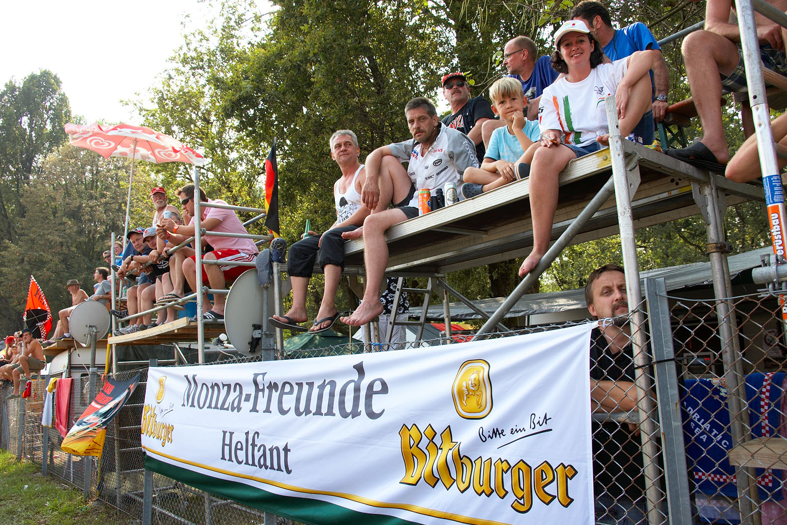 German race fans comfortably sit behind the fence