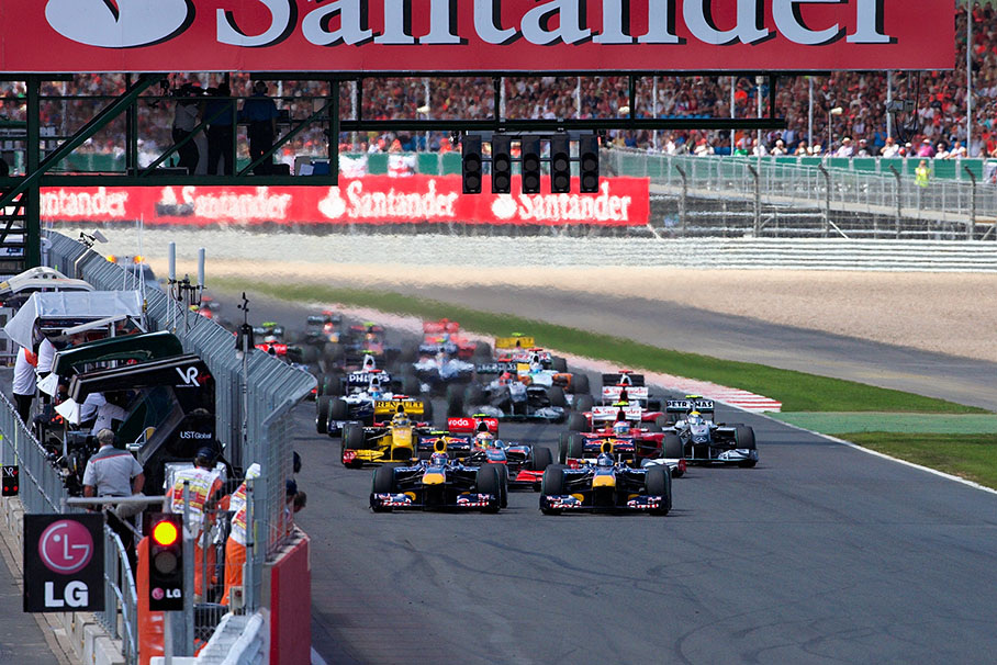 After the start, Red Bull team mates Webber and Vettel come wheel-to-wheel to turn one