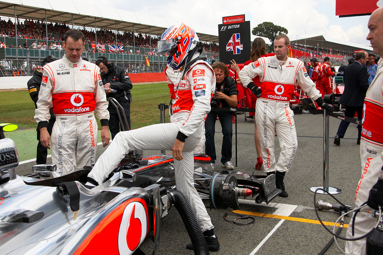 Jenson Button steps in the McLaren Mercedes car on the grid