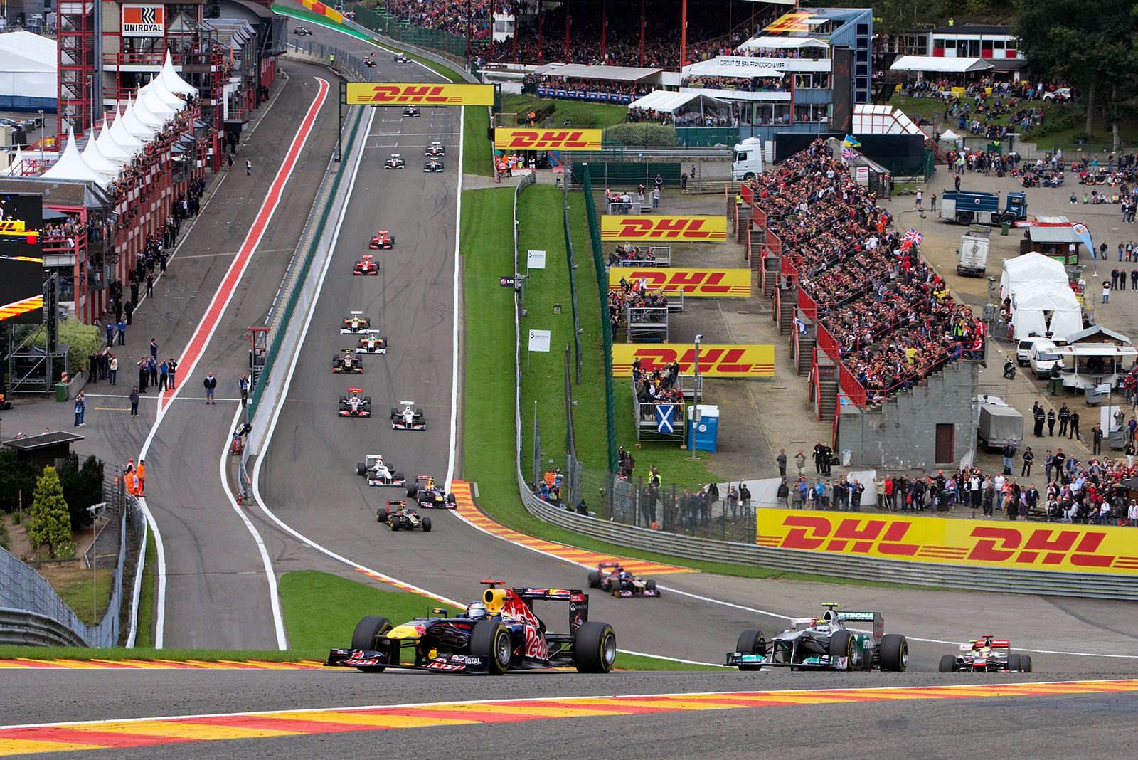 The start field passes Eau Rouge with Vettel in the lead and Rosberg second after a super start