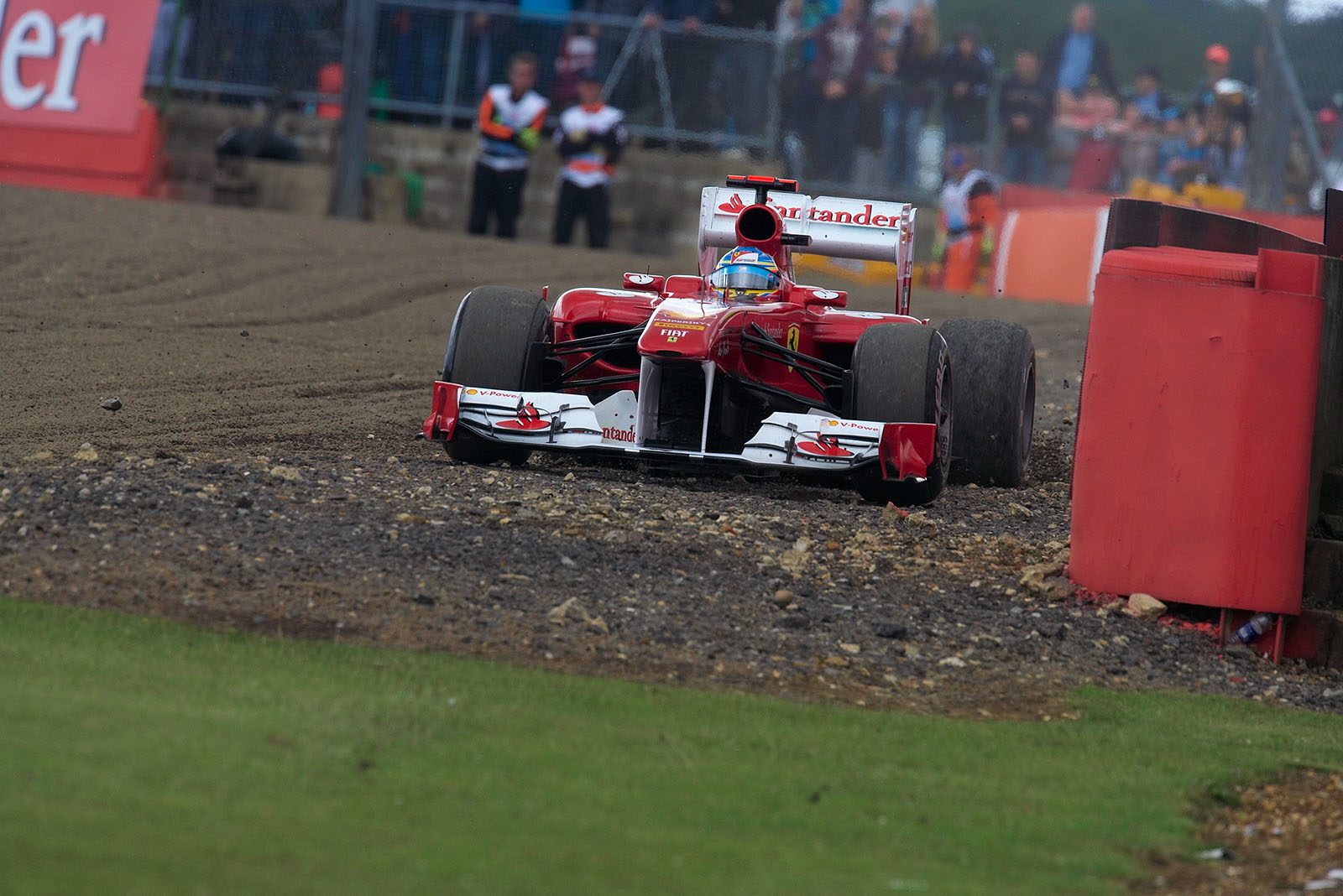 Ferrari's Fernando Alonso takes a derivation behind the gravel trap