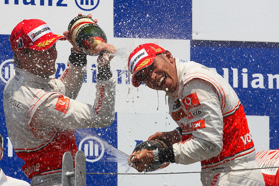 Race winner Lewis Hamilton and second place team mate Jenson Button enjoy a champagne shower