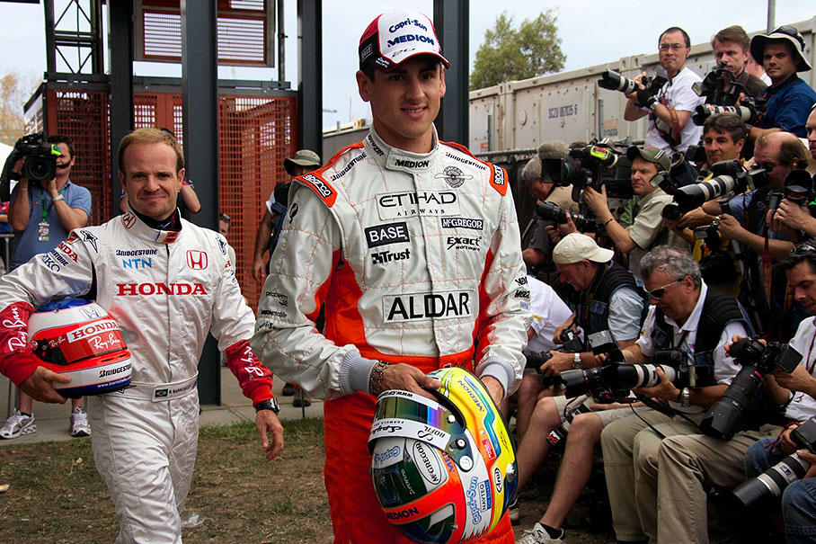First the ceremonial stuff, then the fun - Spyker driver Adrian Sutil atttends his first 'season's start drivers presentation photo', followed by an already quite experienced Rubens Barrichello
