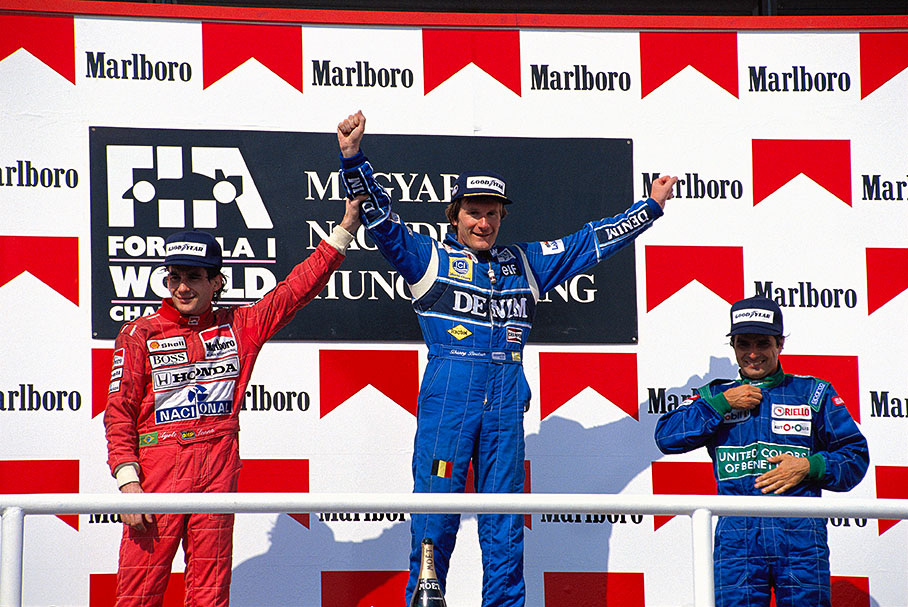 Podium ceremony of the Hungarian Grand Prix 1990: winner Thierry Boutsen, second placed Ayrton Senna and third placed Nelson Piquet