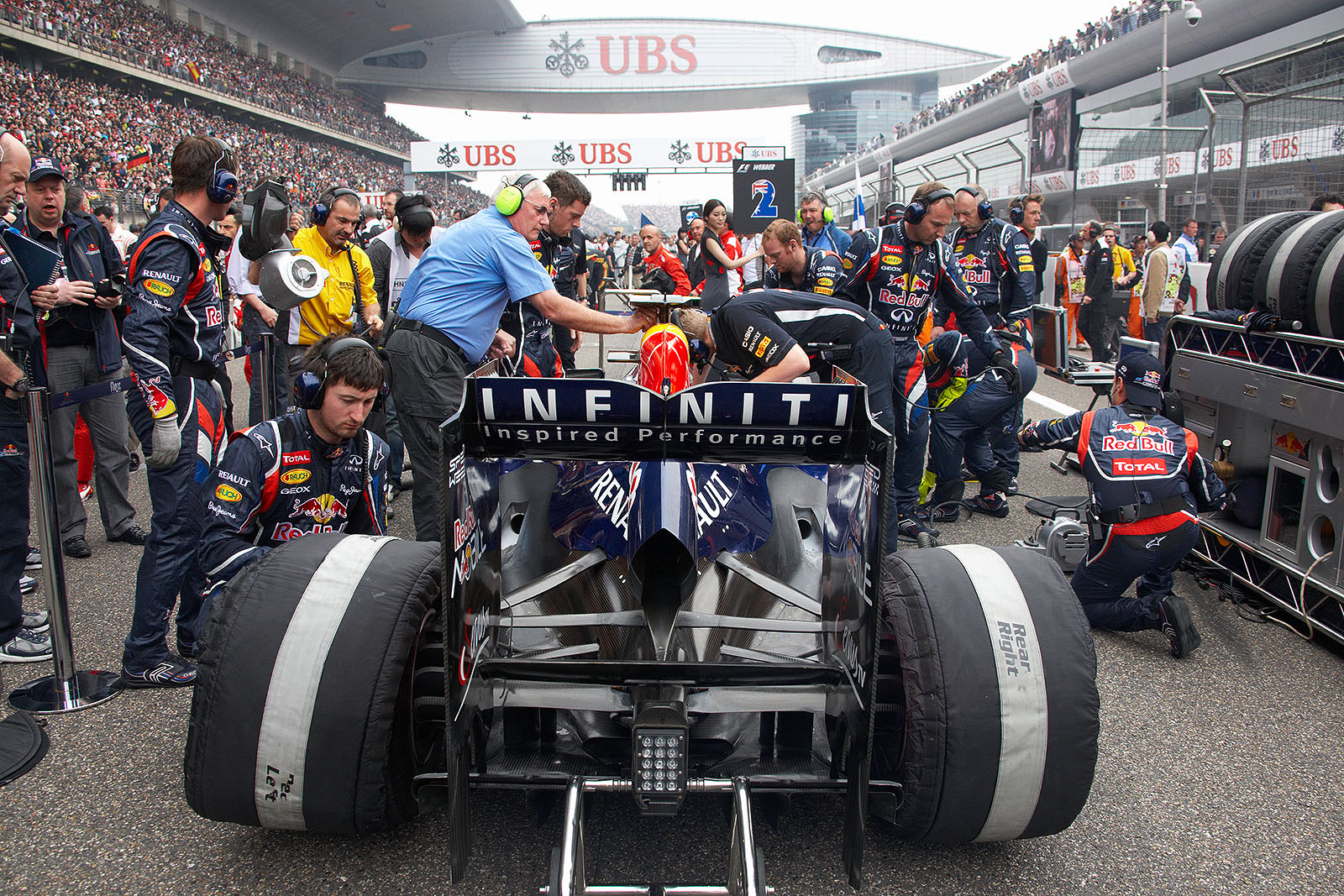 Mark Webber's Red Bull-Renault is prepared on the grid