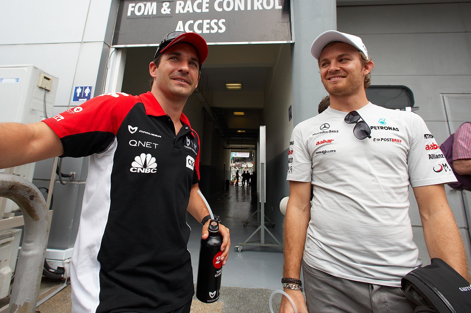 Timo Glock and Nico Rosberg wait for the drivers parade