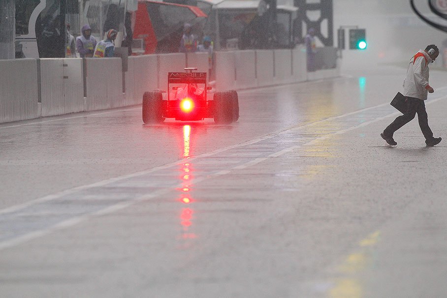 A Red Bull-Renault ploughs through the nearly flooded pitlane