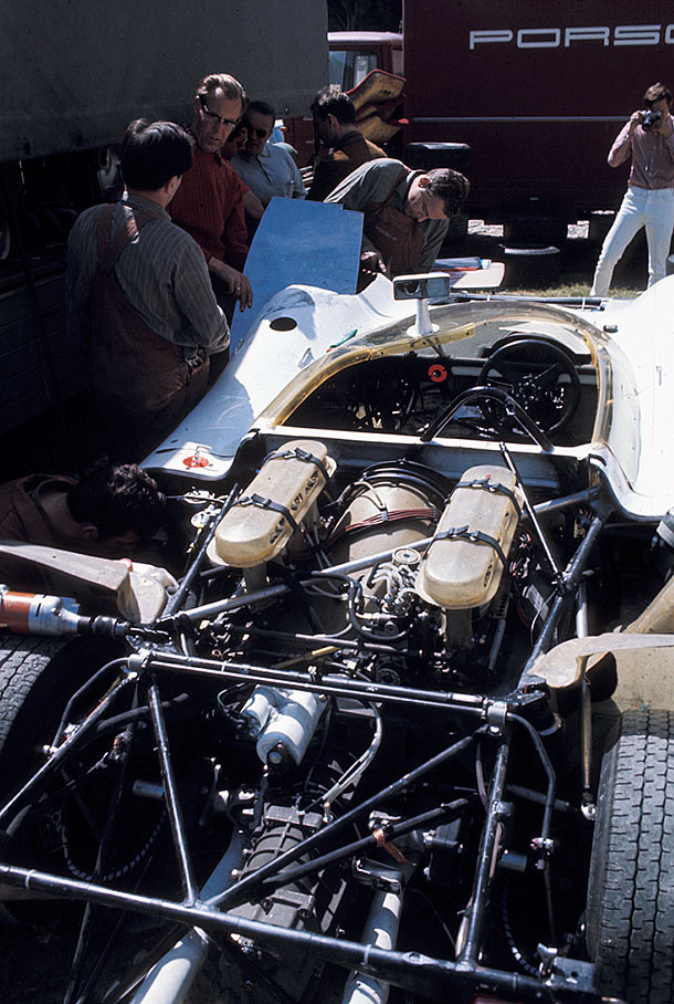Mechanics work on a Porsche under supervision of Porsche engineer Peter Falk