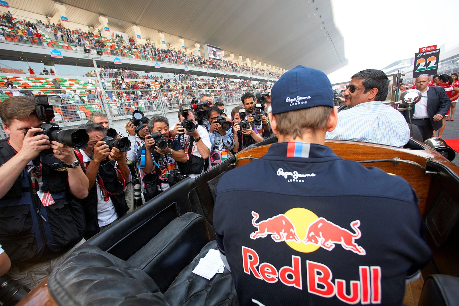 Photographers swarm around Sebastian Vettels historic parade vehicle