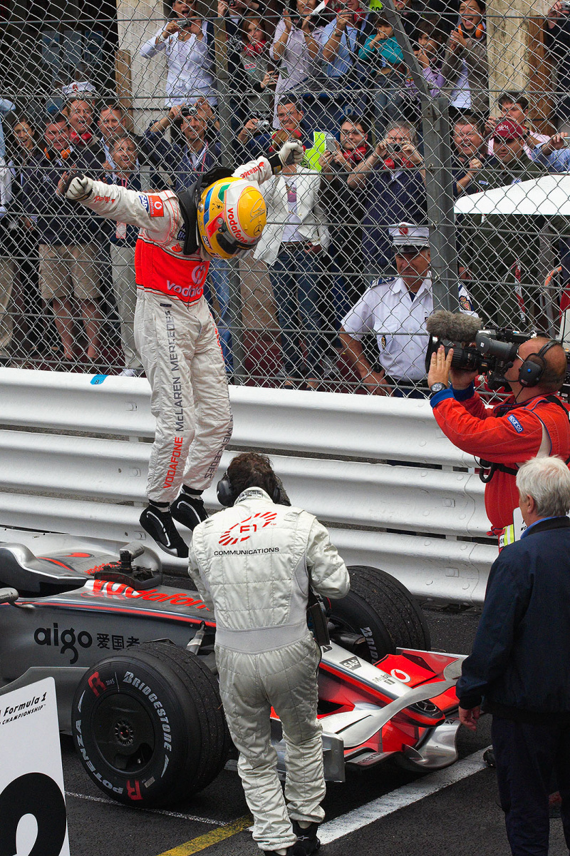 After arriving at podium, Lewis Hamilton jumps from his McLaren car