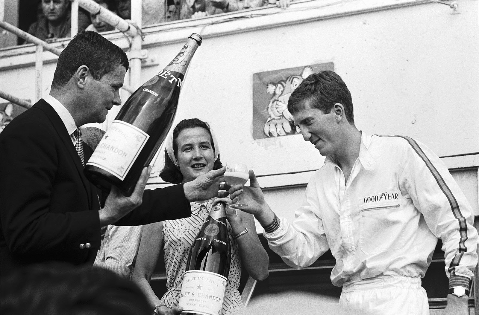 Race winner Jochen Rindt takes a glass of champagne on Le Mans podium 1965