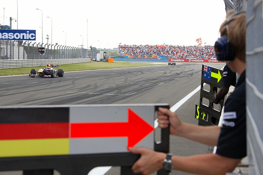 A suddenly third Webber passes the perplexed Red Bull pit wall crew as Vettel just retired
