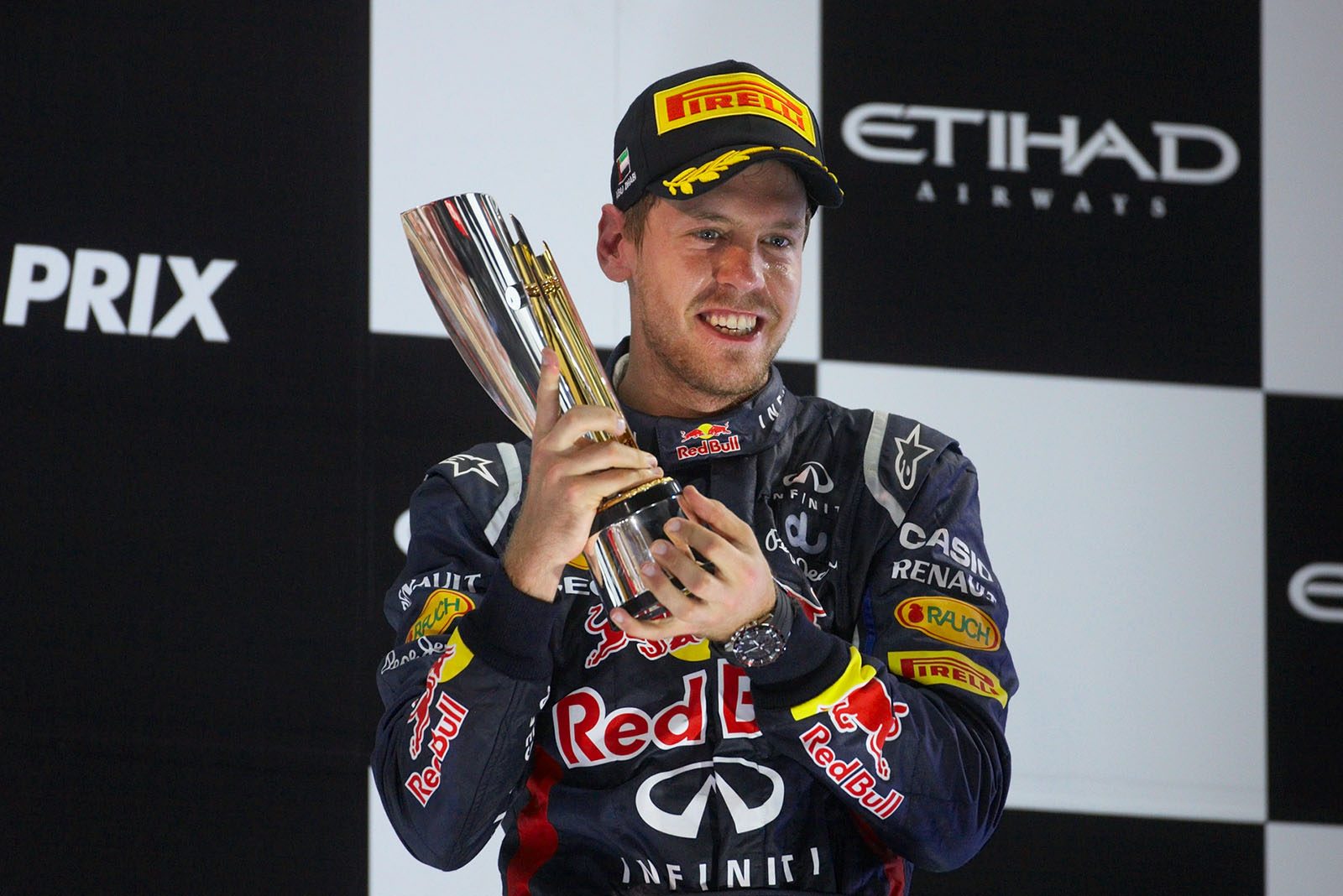 A very happy third placed Sebastian Vettel of Red Bull Racing proudly presents his trophy on the podium