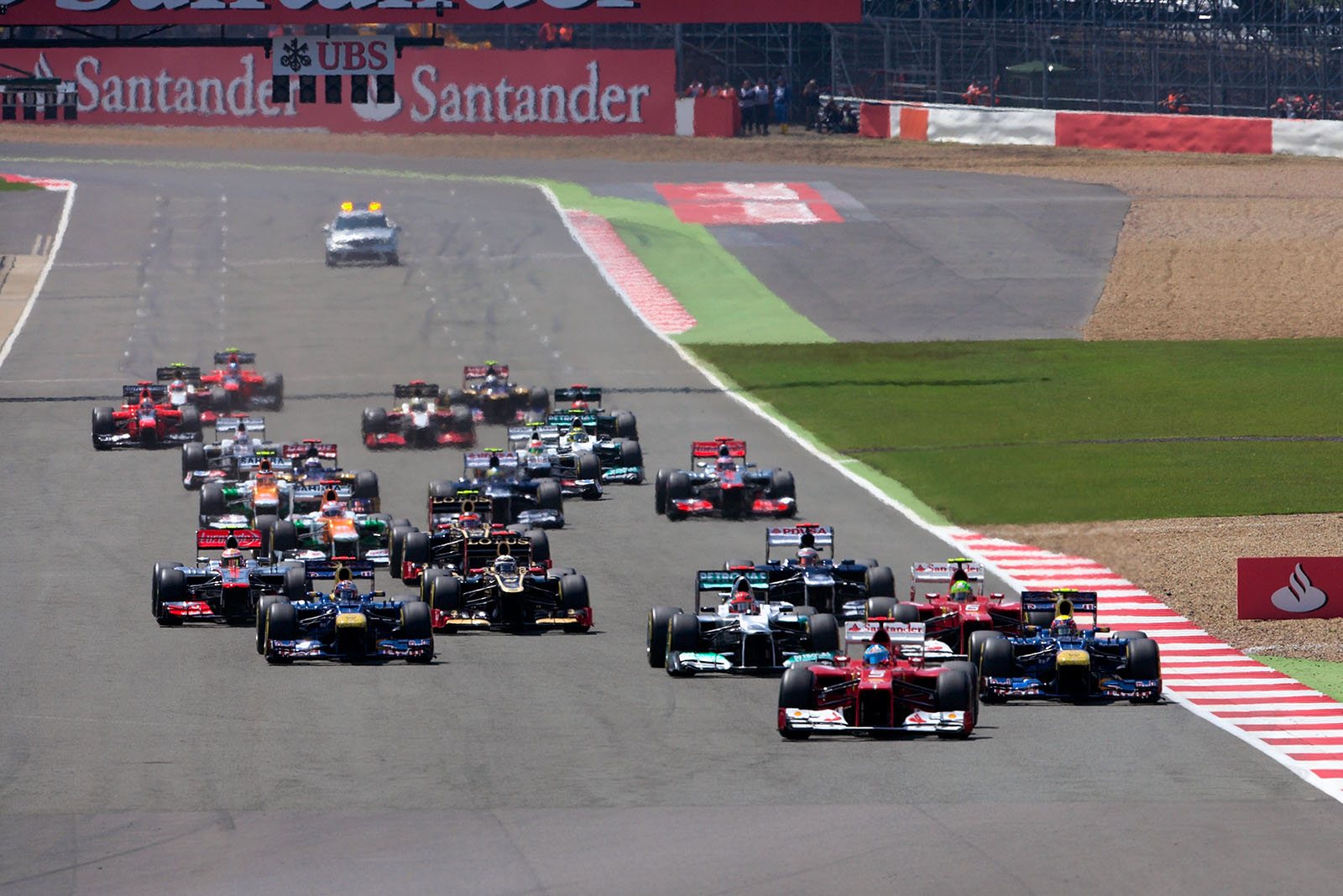 At the start, Alonso's Ferrari is in the lead with Webber behind him
