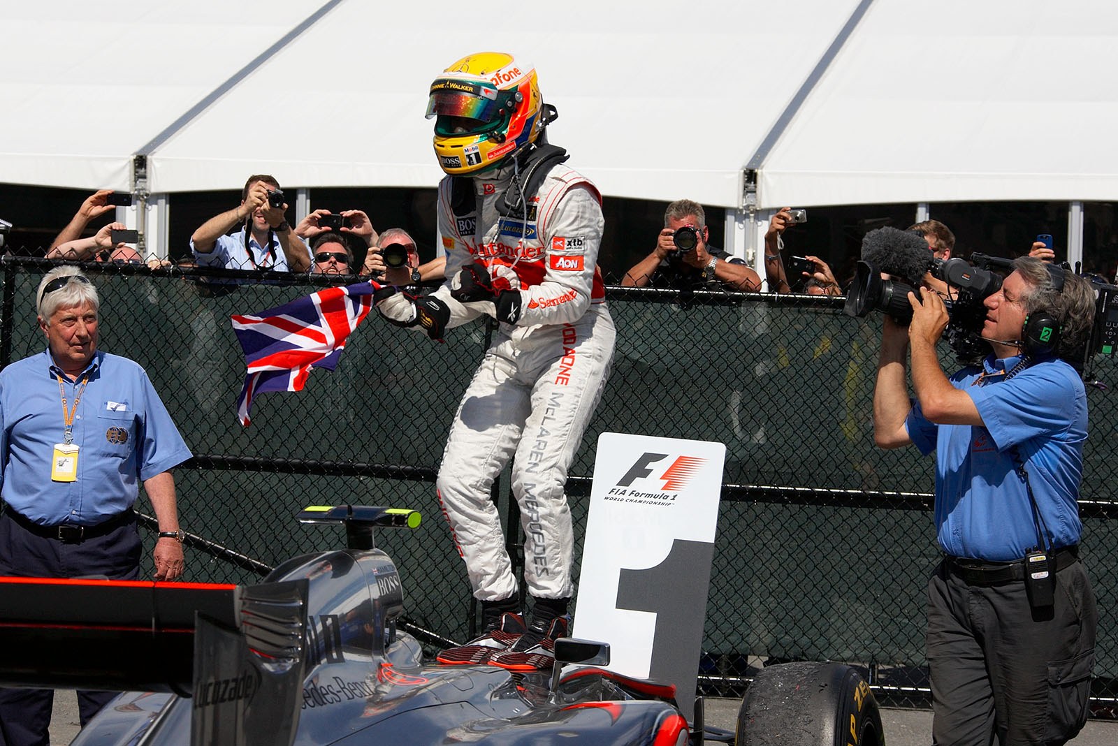 Race winner Lewis Hamilton of McLaren Mercedes jumps on his race car and celebrates in parc ferme