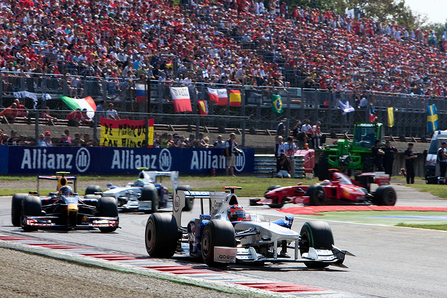 After several race laps BMW Sauber's Robert Kubica passes the first chicane in front of Vettel, teammate Heidfeld and Fisichella