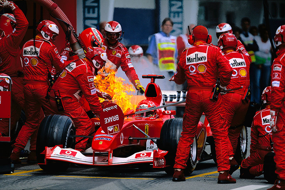 Just a drop of fuel on the hot exhaust causes a burning Ferrari, being quickly extinguished, Austrian GP 2003