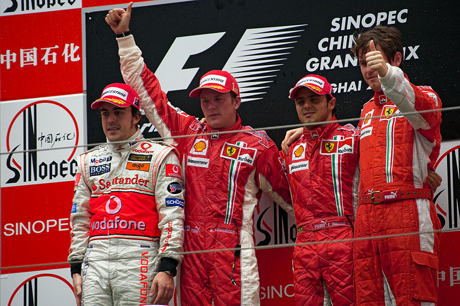Podium group photo of McLaren's second placed Alonso, winner Kimi Raikkonen, third placed Felipe Massa and Ferrari race engineer Rob Smedley