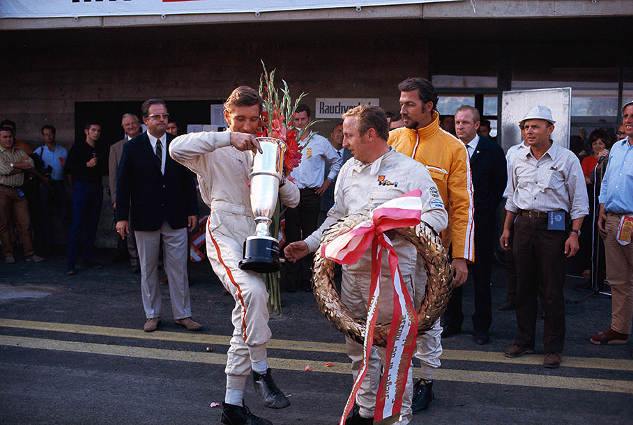 1000 km Zeltweg 1969: Winning driver team Jo Siffert and Kurt Ahrens admire their trophies, second placed Joakim Bonnier watches them from behind