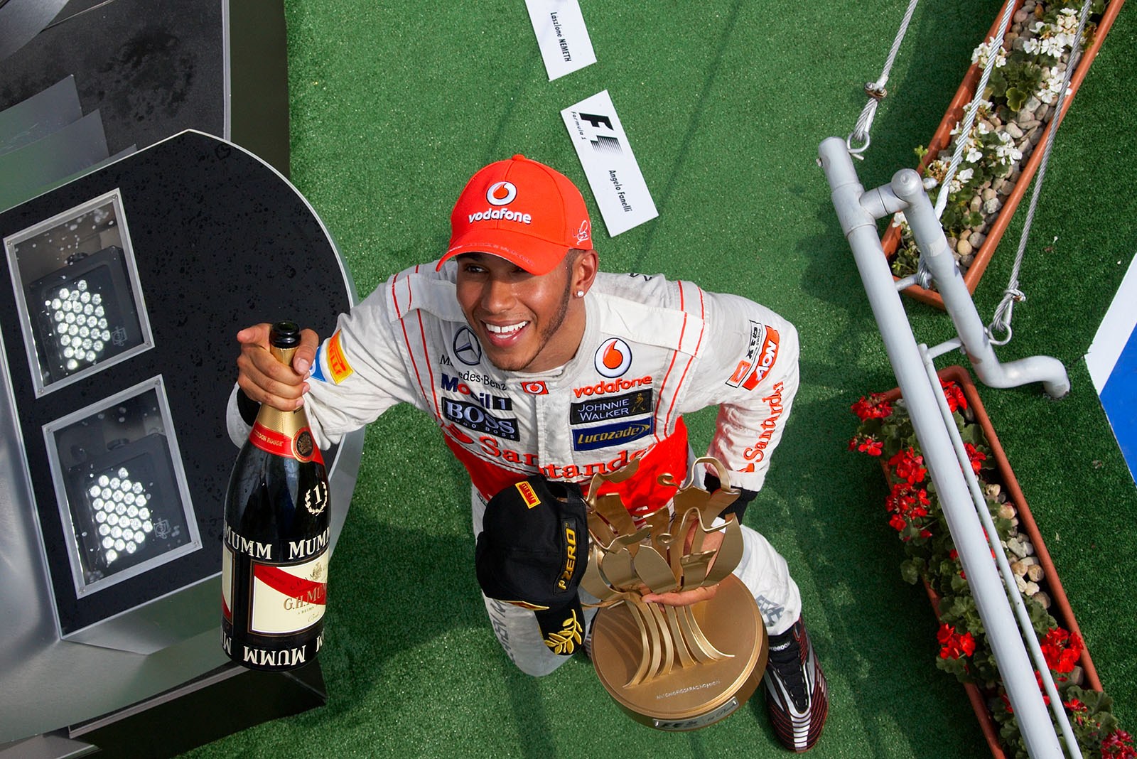 Race winner Lewis Hamilton of McLaren celebrates his achievements on the podium after the Hungarian Grand Prix
