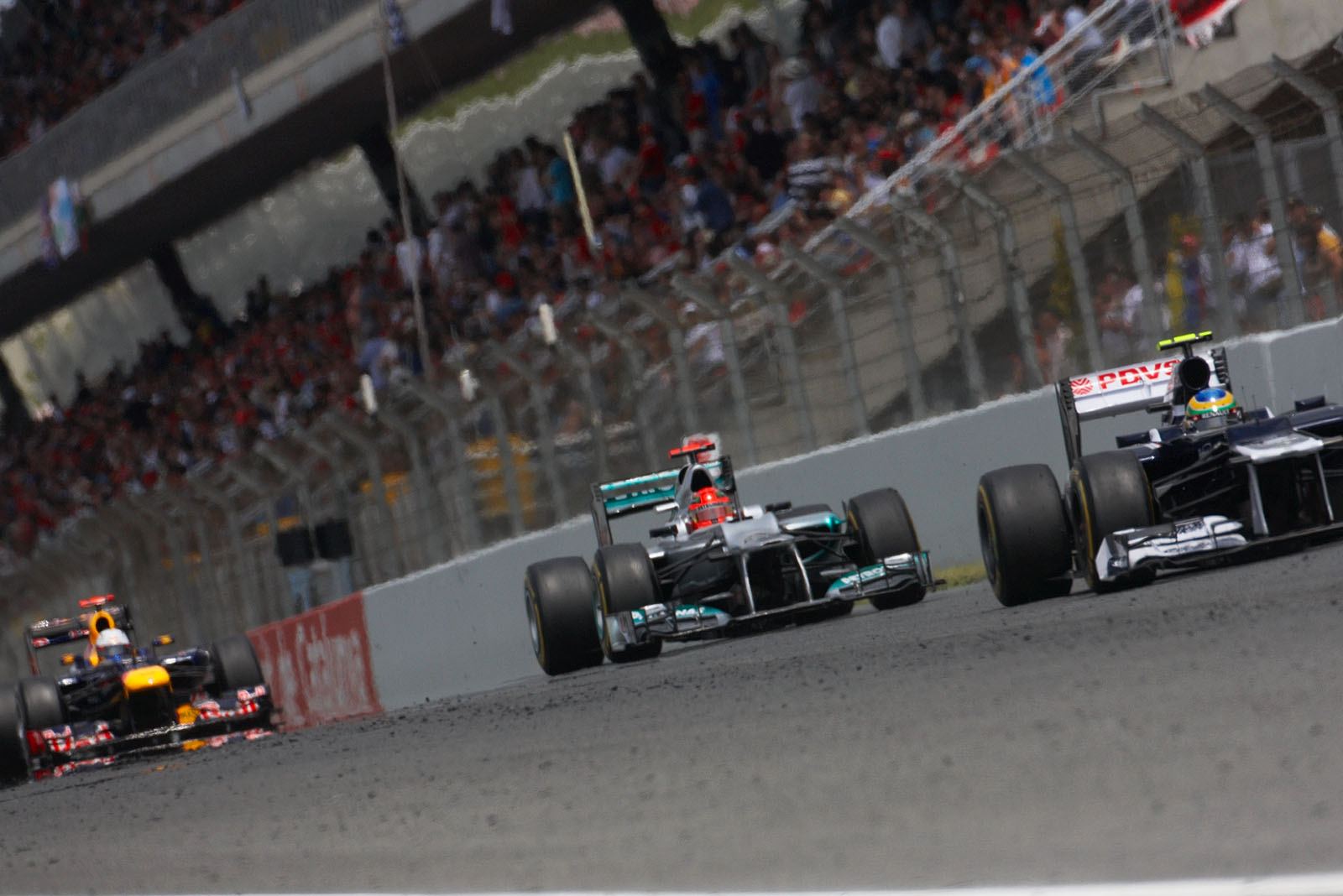 Michael Schumacher, Mercedes GP, pushes behind Bruno Senna's Williams, followed by Vettel