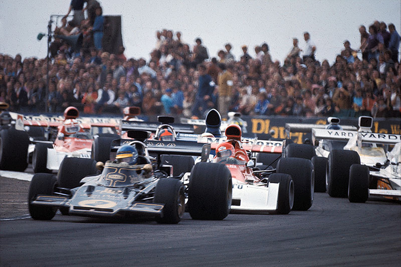 Ronnie Peterson on Lotus-Cosworth 72E leads the field in front of Lauda after the restart following an incidence at the first start of the British GP 1973