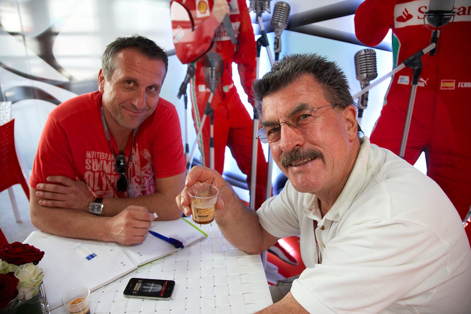 Rainer Schlegelmilch has a ristretto with Miran Alisic in the Ferrari Media motorhome